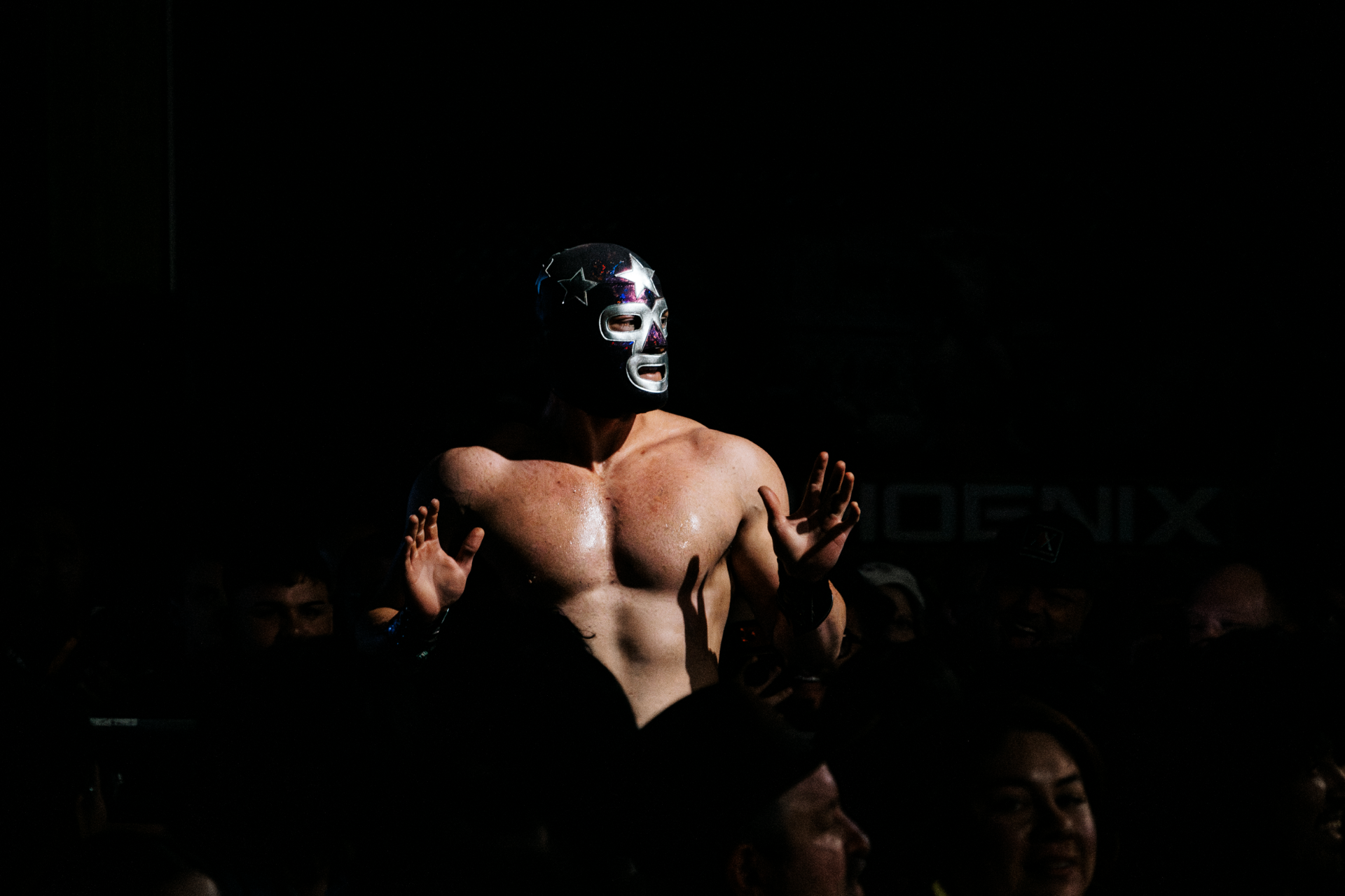 Masked luchador raising the crowd